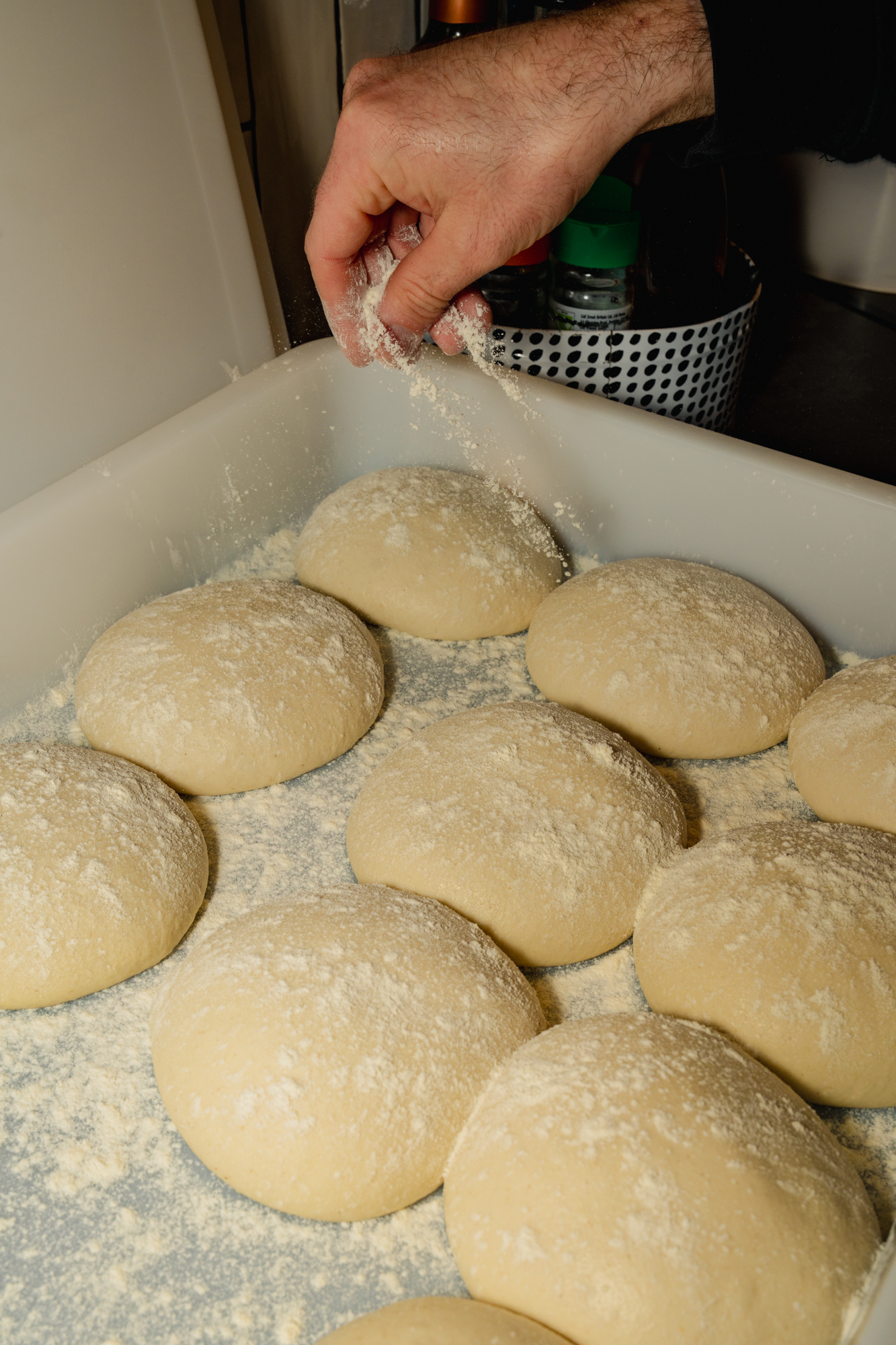 Flouring fresh dough balls